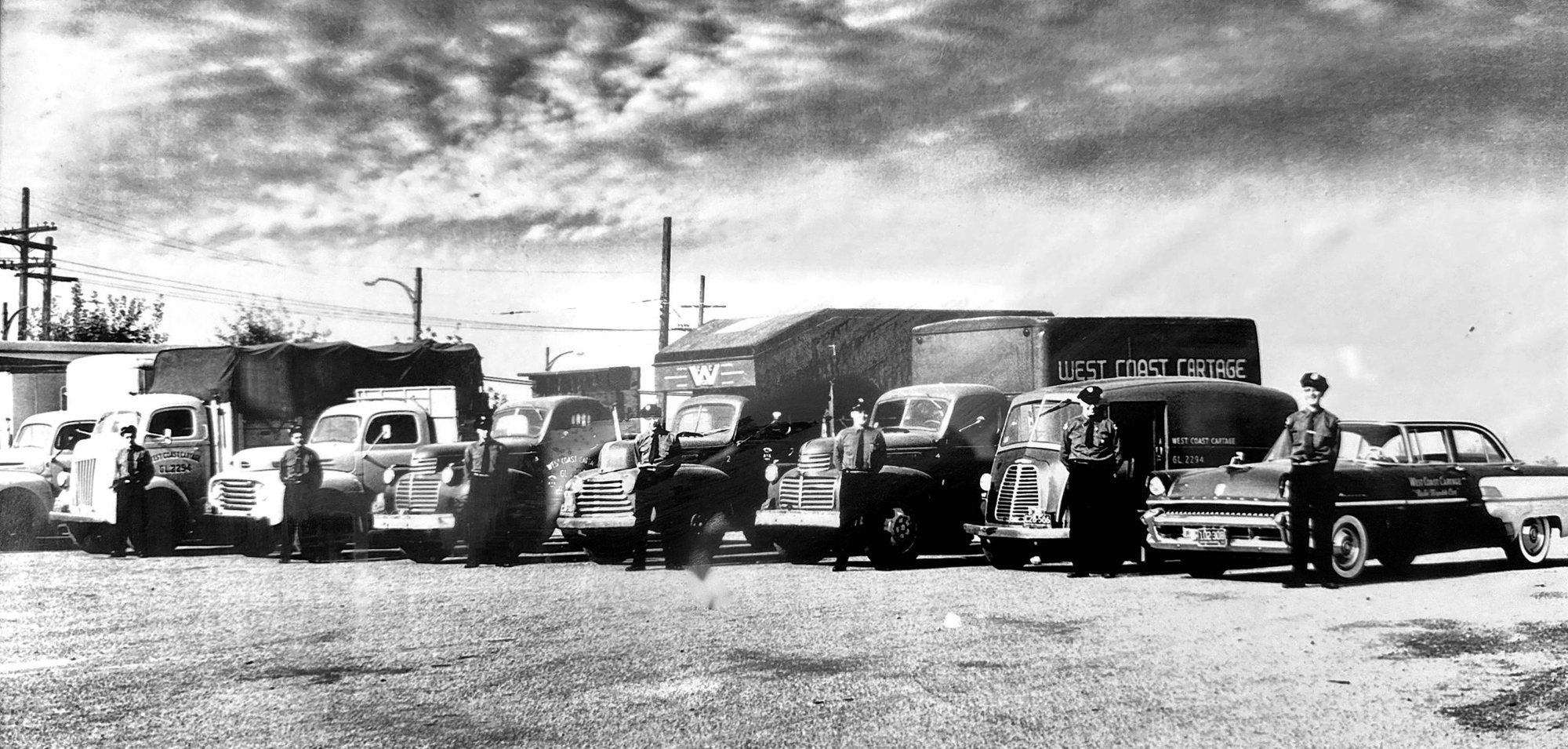 The West Coast Cartage fleet and drivers lined up in the yard, photographed in the late 1940s