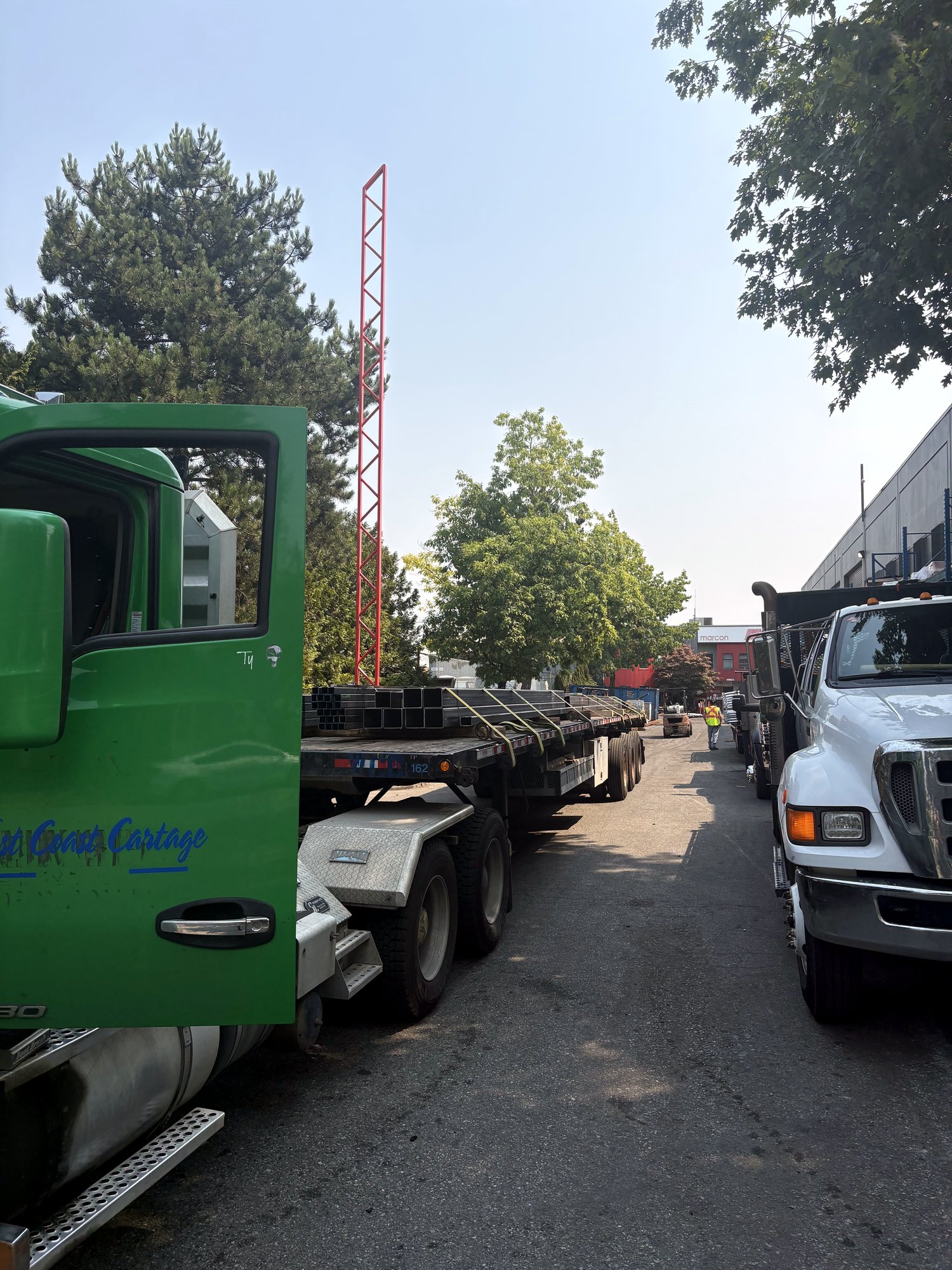 A West Coast Cartage tractor in the yard alongside other trucks